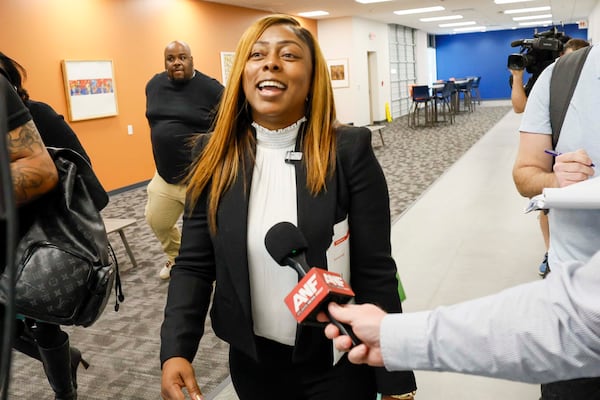 Tiffany Henyard, a candidate for Fulton County Commission, smiles as she speaks to reporters after her hearing before the Fulton County Board of Registration and Elections on Monday, April 20, 2026. The Board voted 3-1 to accept her candidacy after verifying she met the residency requirement. (Miguel Martinez/AJC)