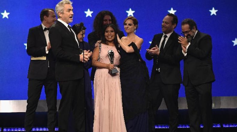 Nicolas Celis (left), Alfonso Cuaron, Yalitza Aparicio, Adam Gough, Marina De Tavira, Jeff Skoll, and Eugenio Caballero accept the Best Picture award for 'Roma' onstage during the 24th annual Critics' Choice Awards at Barker Hangar on Jan. 13, 2019, in Santa Monica, California.
