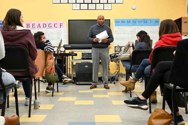 Jarvis Adams (center standing), of the City Schools of Decatur, meets with area parents to discuss the possibility of closing one of five elementary schools in Decatur Thursday, Nov. 13, 2025 at Beacon Hill Middle School. (Daniel Varnado for the AJC)