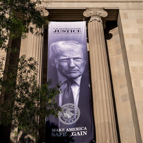 A giant portrait of President Donald Trump looks down from the Justice Department in Washington, Tuesday, June 2, 2026. The Justice Department said it would comply with a court order pausing the implementation of a $1.776 billion settlement fund designed to compensate President Donald Trump's political allies after GOP senators revolted. (AP Photo/J. Scott Applewhite)