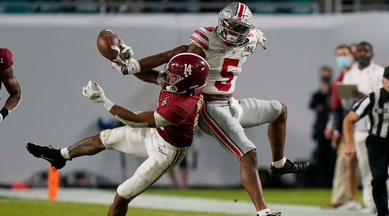 Alabama defensive back Brian Branch breaks up a pass intended for Alabama wide receiver Javon Baker during the first half of an NCAA College Football Playoff national championship game, Monday, Jan. 11, 2021, in Miami Gardens, Fla.