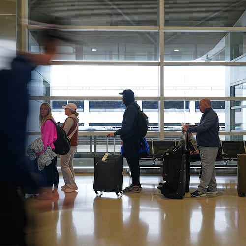 Travelers wait in lines at the Detroit Metropolitan Airport, Sunday, Nov. 9, 2025, in Detroit. (AP Photo/Ryan Sun)