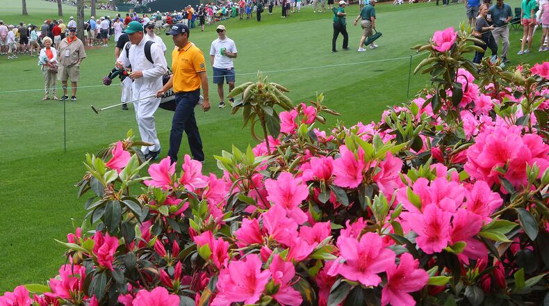 Former UGA golfer Erik Compton and his caddy walk past azaleas in full bloom at the 6th hole at Augusta National in 2015.