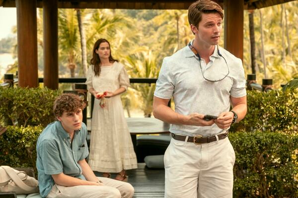 This image released by HBO shows Sam Nivola, from left, Sarah Catherine Hook, and Patrick Schwarzenegger in a scene from "The White Lotus." (Fabio Lovino/HBO via AP)