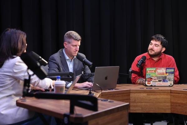 Patricia Murphy (from left) and Greg Bluestein prepare for a “Politically Georgia” podcast recording with Brayan Ramirez, co-chair of the Atlanta Democratic Socialists of America, at the AJC office in Atlanta on Monday. (Arvin Temkar/AJC)