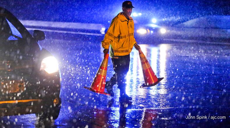 Weather hampered efforts to clear a tractor-trailer crash that was jamming traffic on I-285 and I-20 on the westside. The truck overturned on I-285 northbound just north of I-20, slamming into the median wall and knocking concrete into the southbound lanes.