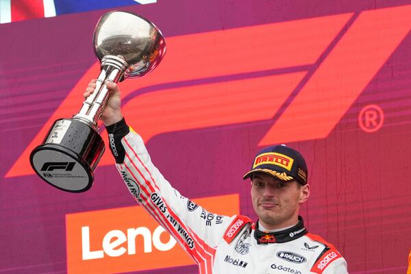 Red Bull driver Max Verstappen of the Netherlands celebrates with his trophy on the podium after the Japanese Formula One Grand Prix at the Suzuka Circuit in Suzuka, central Japan, Sunday, April 6, 2025. (AP Photo/Shuji Kajiyama)