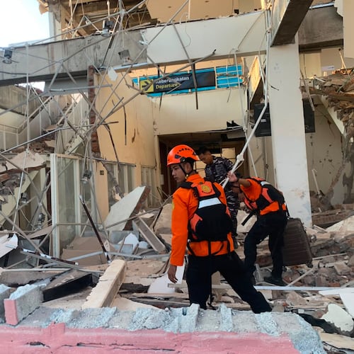 In this photo released by the Indonesian National Search and Rescue Agency (BASARNAS), rescuers search for victims at a damaged building following an earthquake in Maumere, East Nusa Tenggara Province, Indonesia, Saturday, Aug. 15, 2026. (BASARNAS via AP)