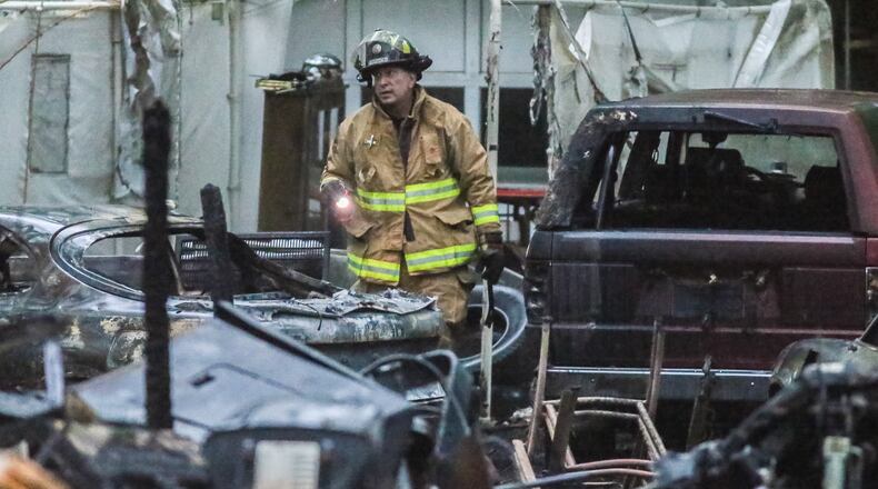 Investigators were looking into a fire that killed two people in Walton County on Mon., May 16, 2016. JOHN SPINK / JSPINK@AJC.COM
