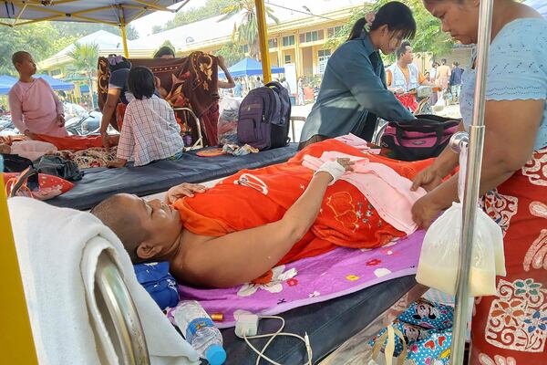 An injured receives treatment outside Sagaing General Hospital in Sagaing, Myanmar, Tuesday, April 1, 2025. (Democratic Voice of Burma via AP)