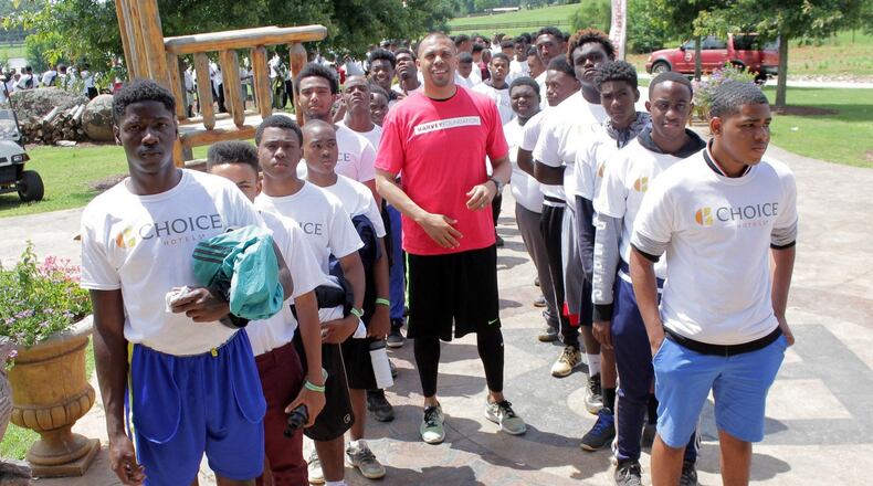 After helping sponsor the Steve Harvey Mentoring Program for Young Men in 2009, Benjamin Raymond (center) became a regular speaker and mentor at the annual event. He is pictured here with the more 250 boys who attended last week’s camp at the Rock Ranch in Barnesville. CONTRIBUTED BY ITORO UMONTUEN