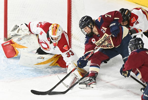 Montreal Victoire's Laura Stacey (7) tries a wraparound against Ottawa Charge goaltender Gwyneth Philips (33) during third overtime period PWHL hockey playoff action in Laval, Quebec, Sunday, May 11, 2025. (Graham Hughes/The Canadian Press via AP)