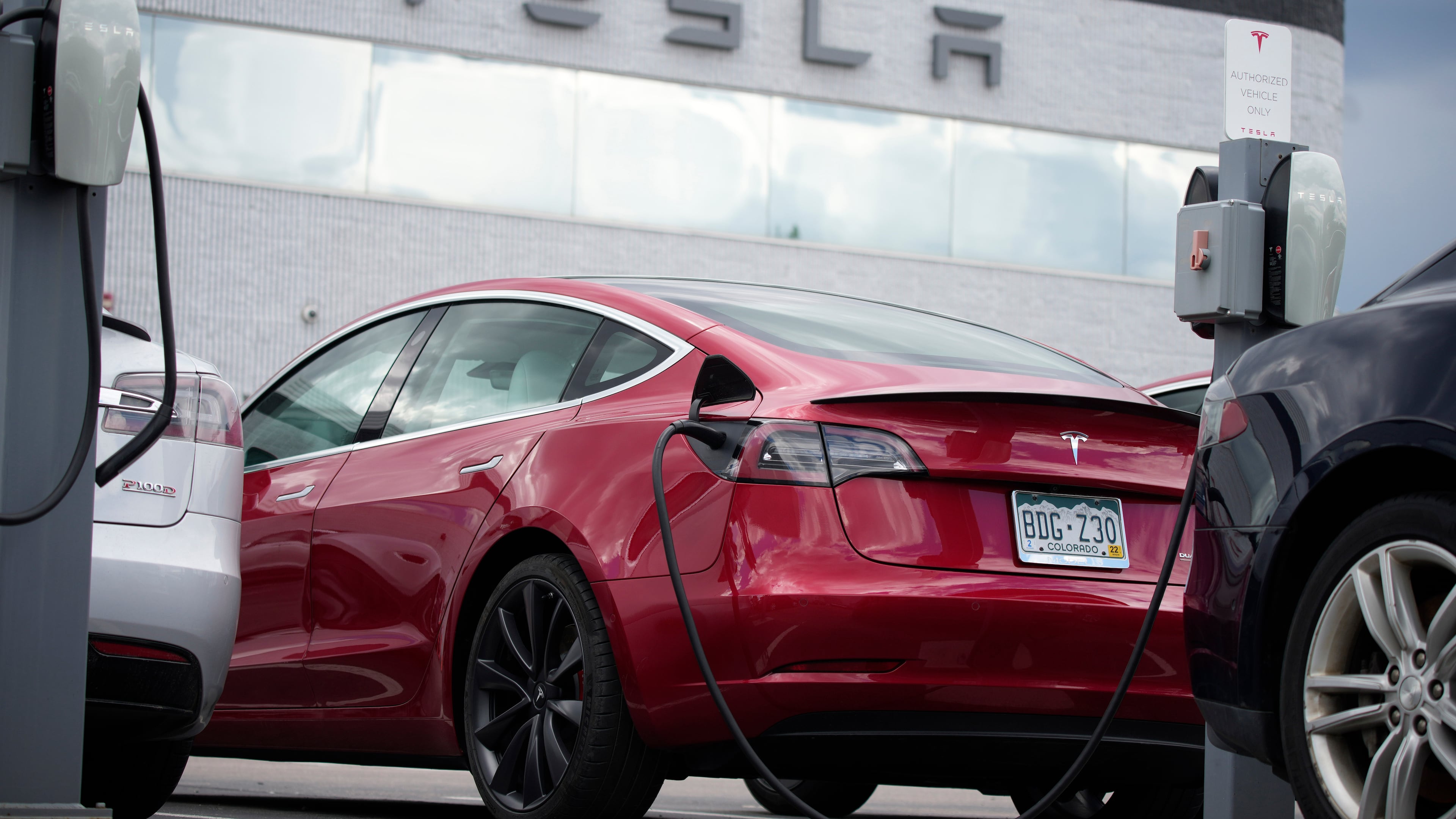FILE - A 2021 Model 3 sedan sits in a near-empty lot at a Tesla dealership in Littleton, Colo. June 27, 2021. (AP Photo/David Zalubowski, File)