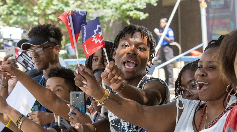 Chauncey Delaney (Center) cheers on the parade as it moves up Decatur St towards Centennial Park during the Juneteenth Atlanta Parade and Music Festival Saturday, June 17, 2023. (Steve Schaefer/steve.schaefer@ajc.com)