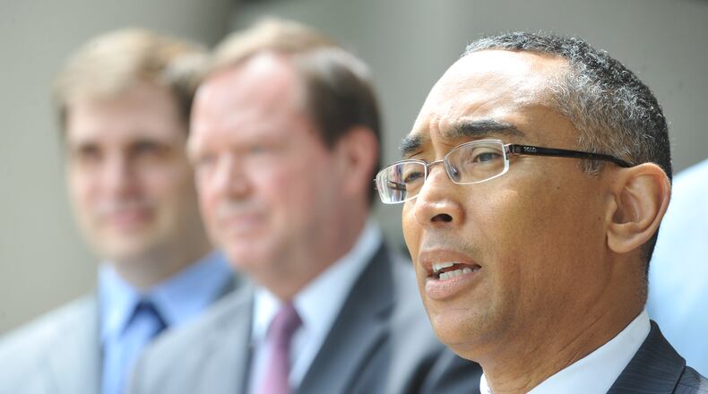 Burrell Ellis and his defense team speak in front of their offices in Decatur.