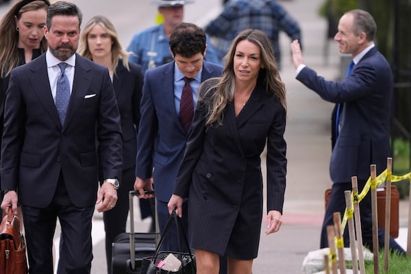 Karen Read arrives with her defense team for her trial at Norfolk Superior Court, Tuesday, April 22, 2025, in Dedham, Mass. (AP Photo/Charles Krupa)