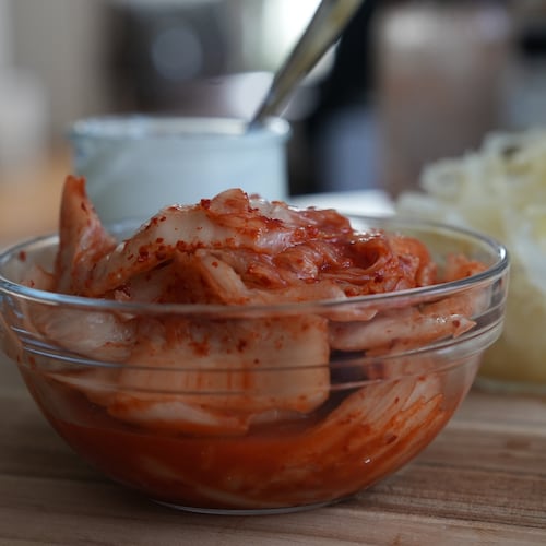 Kimchi, sauerkraut and yogurt are displayed on a kitchen table in New York on July 10, 2026. (AP Photo/Mary Conlon)