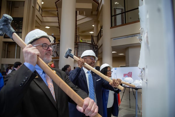 Clayton State University officials break down a wall to make room for an expansion of its College of Health building. (Courtesy of Clayton State University)
