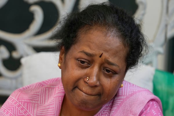 A woman cries next to the body of 14-year-old Divyanshi Shivakumar, who lost her life in Wednesday's deadly stampede during celebrations outside a stadium for Royal Challengers Bengaluru, winners of the Indian Premier League, at her residence ahead of her last rites in Bengaluru, India, Thursday, June 5, 2025. (AP Photo/Aijaz Rahi)