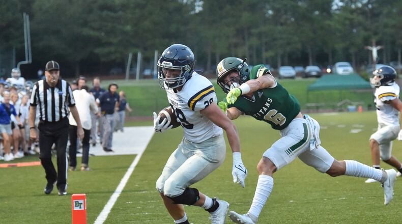 Marist's running back Quinn Gooding (29) scores a touchdown past Blessed Trinity's Ashton Abrew (6) in the first half Friday, Aug. 27, 2021, at Blessed Trinity Catholic High School in Roswell. (Hyosub Shin / Hyosub.Shin@ajc.com)