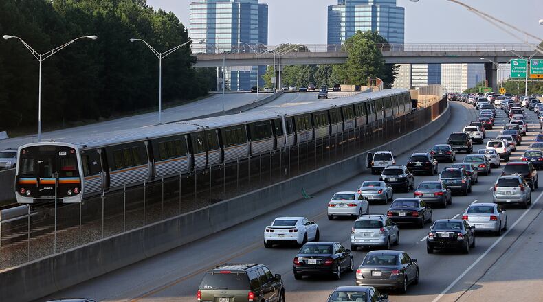 August 29, 2013 Sandy Springs: A MARTA train makes its way North past Ga. 400 traffic on Thursday afternoon August 29, 2013. BEN GRAY / BGRAY@AJC.COM