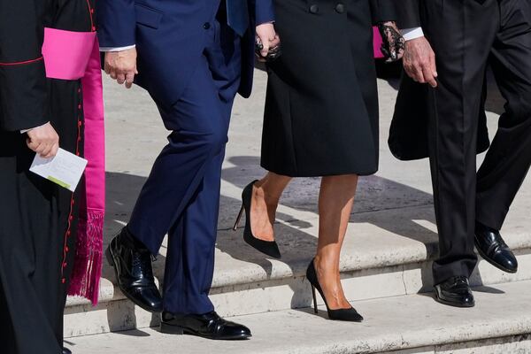 President Donald Trump and first lady Melania Trump, center, arrive for the funeral of Pope Francis in St. Peter's Square at the Vatican, Saturday, April 26, 2025. (AP Photo/Gregorio Borgia)