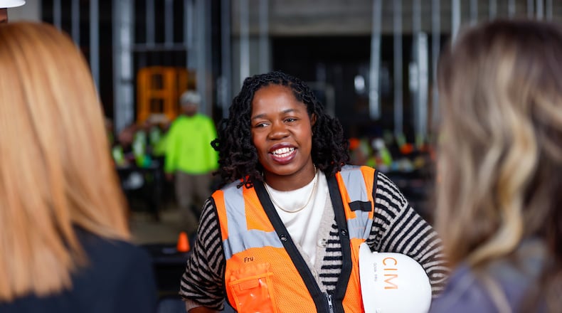 Olivia Fru, a Senior Construction Manager at CIM Group, speaks with co-workers as the company celebrates a milestone reaching the highest point of the Phoenix Hotel on Wednesday, December 18, 2024. The boutique hotel is part of six buildings constructed at Centennial Yards in Downtown Atlanta.
(Miguel Martinez / AJC)