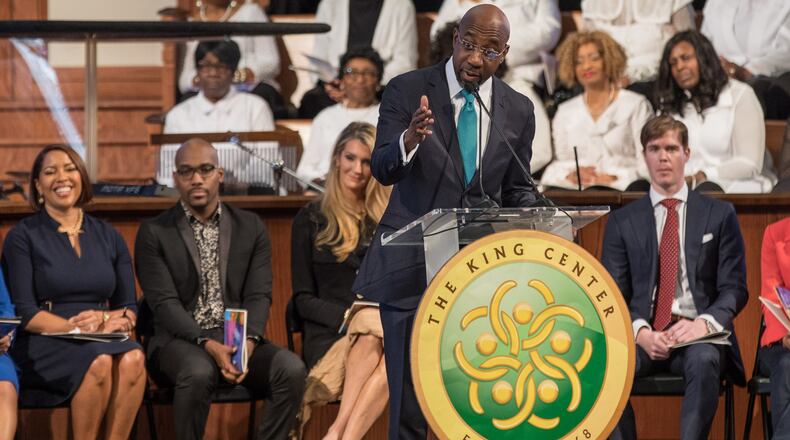 With U.S. Sen. Kelly Loeffler in the background, the Rev. Raphael G. Warnock speaks during the Martin Luther King, Jr. annual commemorative service at Ebenezer Baptist Church in Atlanta on Monday, Jan. 20, 2020. BRANDEN CAMP/SPECIAL
