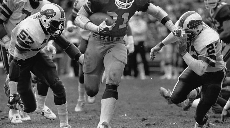 William Andrews pushes through a hole against the Buffalo Bills in 1984 (Louie Favorite/AJC staff)