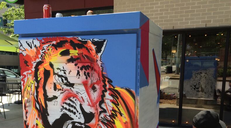 Adam Crawford’s tiger is at the corner of West Ponce de Leon Avenue and Ponce Place in front of Taziki’s Mediterranean Cafe. Photo courtesy of Larry Holland.