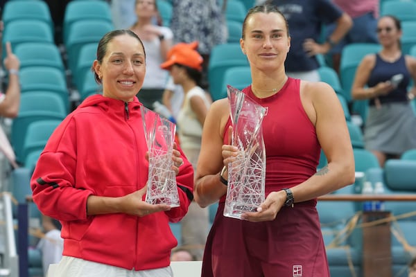 Aryna Sabalenka, right, holds Butch Buchholz winners trophy as Jessica Pegula holds the finalist trophy following the women's singles final match at the Miami Open tennis tournament, Saturday, March 29, 2025, in Miami Gardens, Fla. (AP Photo/Marta Lavandier)