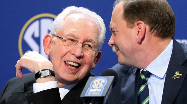 SEC Commissioner Mike Slive, left, speaks with SEC Network President Justin Connolly during a news conference the day before the SEC Championship game at the Georgia Dome in Atlanta, December 6, 2013. JASON GETZ / JGETZ@AJC.COM