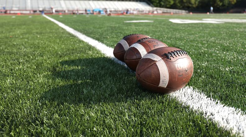 Footballs are lined up on the field prior to the Lovett-GAC high school football matchup on Sept. 11. (Jason Getz/Special to the AJC)