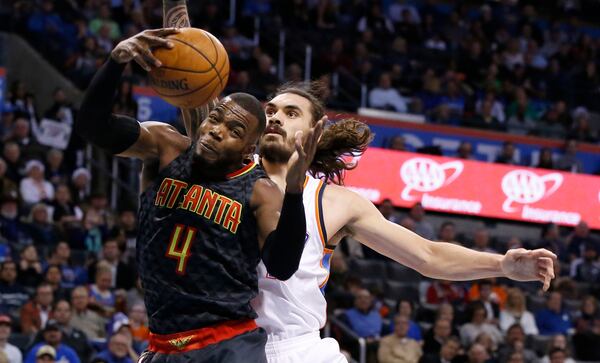 Atlanta Hawks forward Paul Millsap (4) grabs a rebound in front of Oklahoma City Thunder center Steven Adams, right, in the first half of an NBA basketball game in Oklahoma City, Monday, Dec. 19, 2016. (AP Photo/Sue Ogrocki)