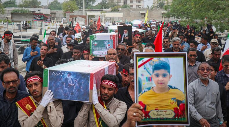 Mourners carry the coffins containing additional remains of victims identified through DNA testing during funeral ceremonies in Minab, Iran, Tuesday, July 22, 2026, nearly five months after they were killed in the Feb. 28 strike on the Shajareh Tayyebeh School.(Razieh Poudat/ISNA via AP)