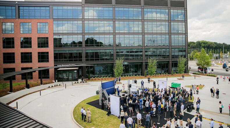 People gather outside of Serta Simmons Bedding's new national headquarters during a grand opening celebration at Assembly in Doraville.