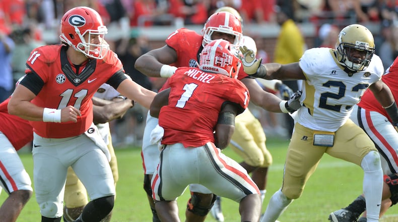 Georgia Bulldogs quarterback Greyson Lambert (11) hands off to Georgia Bulldogs running back Sony Michel (1) in the second half at Bobby Dodd Stadium on Saturday, November 28, 2015. Georgia Bulldogs won 13 - 7 over the Georgia Tech Yellow Jackets. HYOSUB SHIN / HSHIN@AJC.COM