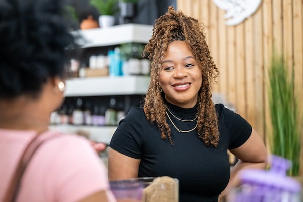 Ty Jenkins helps a customer at Olive Branch in downtown Decatur, April 29, 2025. (Bita Honarvar for the AJC)