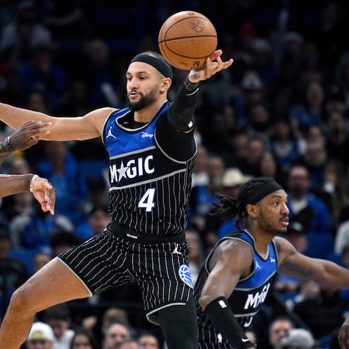 Orlando Magic guard Jalen Suggs (4) deflects a pass by Miami Heat guard Davion Mitchell, left, during the second half of an NBA Cup basketball game, Tuesday, Dec. 9, 2025, in Orlando, Fla. (AP Photo/Phelan M. Ebenhack)