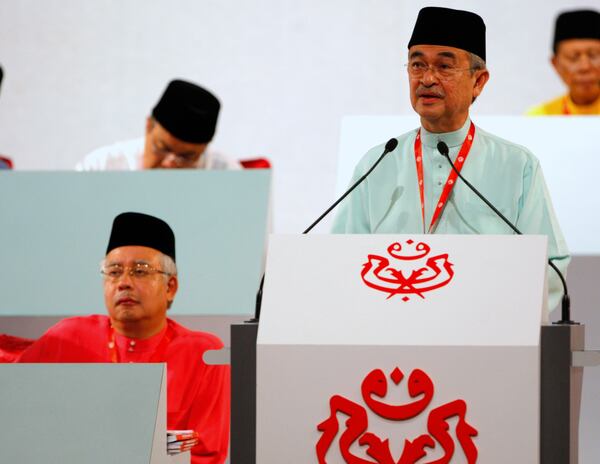 FILE - Malaysia's Prime Minister Abdullah Ahmad Badawi, right, delivers his keynote address United Malays National Organization (UMNO) annual general assembly in Kuala Lumpur, Thursday, March 26, 2009. (AP Photo/Vincent Thian, File)