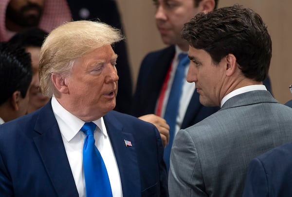 FILE - Canadian Prime Minister Justin Trudeau, right, speaks with U.S. President Donald Trump at the start of the a plenary session at the G20 Summit in Osaka, Japan, June 29, 2019. (Adrian Wyld/The Canadian Press via AP, File)