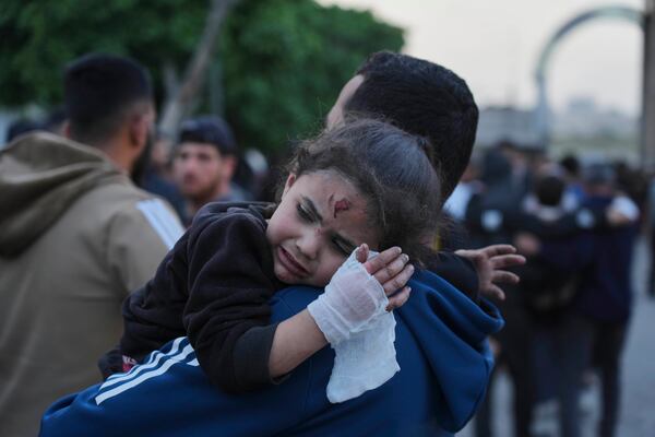 A young Palestinian girl who was injured in an Israeli airstrike, is brought for a treatment at the Baptist Hospital in Gaza City, on Thursday, April 3, 2025. (AP Photo/Jehad Alshrafi)