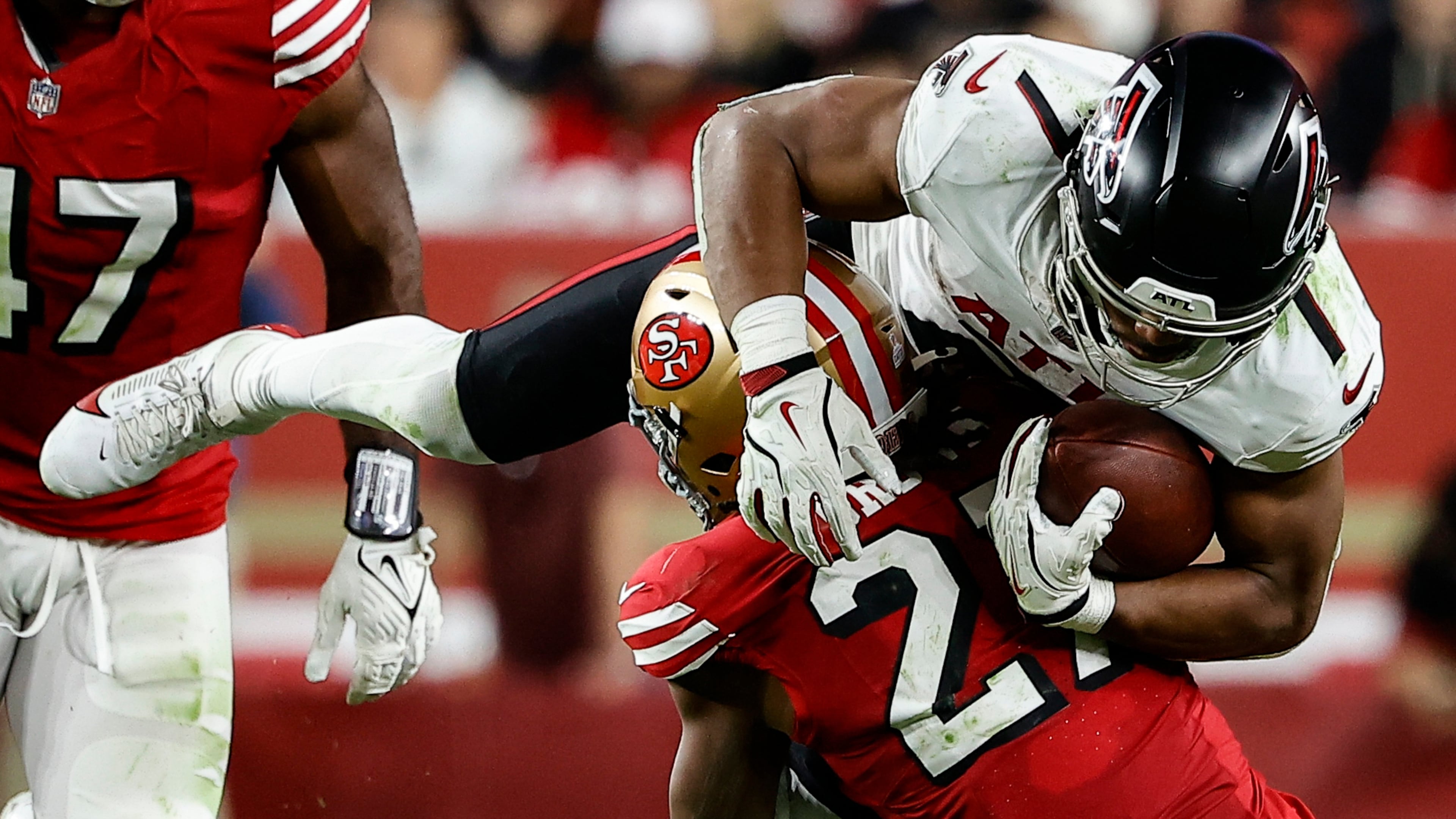 San Francisco 49ers safety Ji'Ayir Brown tackles Atlanta Falcons running back Bijan Robinson in the second half of Sunday's game. Robinson was held to less than 100 yards in the game. (Kelley L Cox/AP)