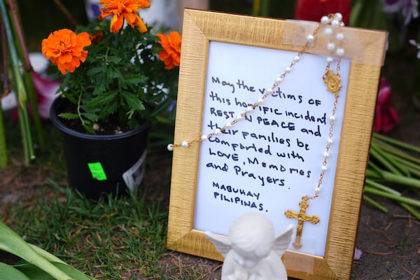 A handwritten note in a frame is seen at a growing memorial for victims the day after a driver killed multiple people during a Filipino community festival Sunday, April 27, 2025, in Vancouver, British Columbia. (AP Photo/Lindsey Wasson)