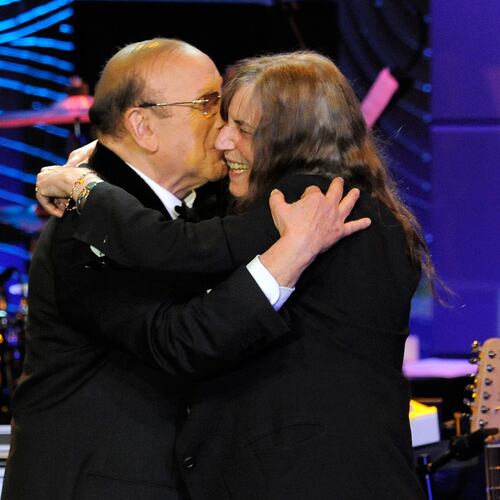 FILE - Music producer Clive Davis, left, and recording artist Patti Smith embrace onstage at the Clive Davis Pre-Grammy Gala in Beverly Hills, Calif., on Feb. 9, 2013. (Photo by Chris Pizzello/Invision/AP, File)