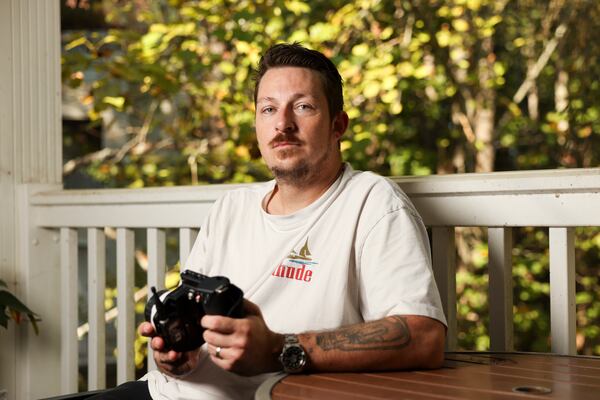 Case Norton, a camera operator, held a Wireless Follow Focus he used on productions at his Sandy Springs home last year. (Jason Getz/AJC)