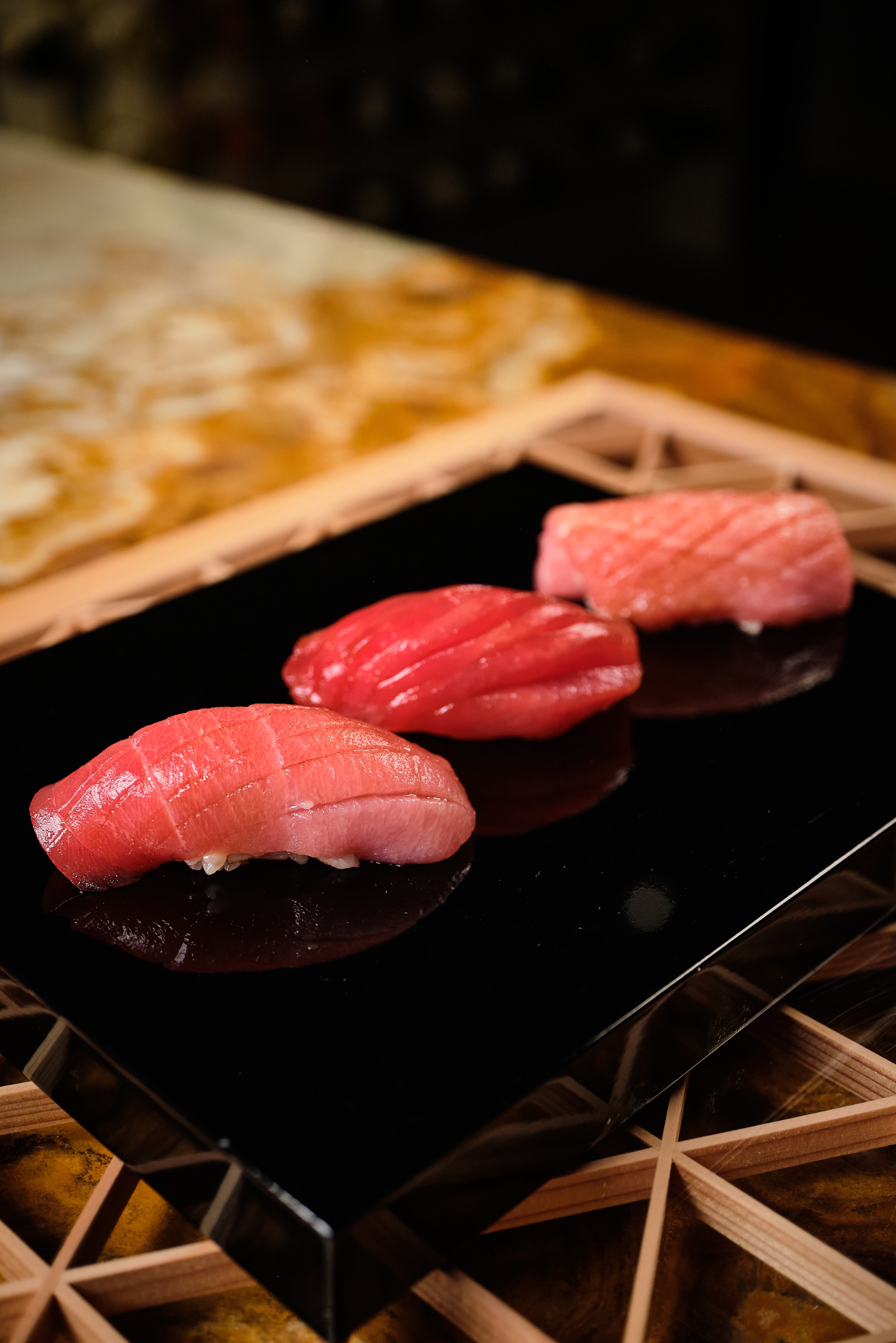 In Ryokou's nigiri course, three pieces are cut from the same fish so the diner can taste medium fatty, lean and fatty tuna in quick succession. (Courtesy of Brandon Amato/Ryokou)