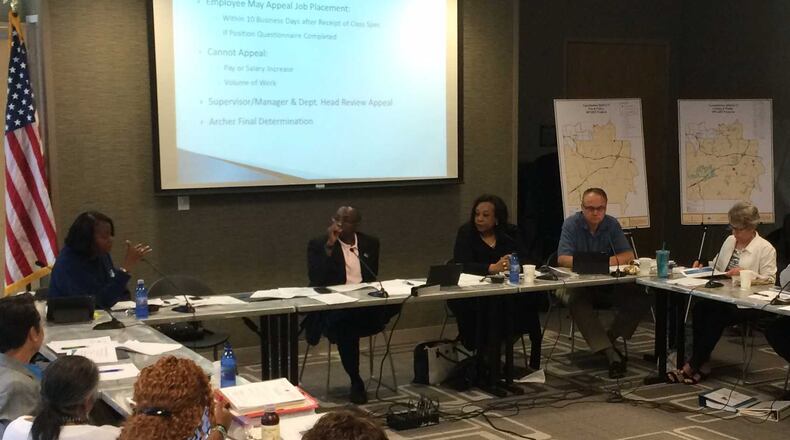 DeKalb County commissioners and officials discussed a proposal to raise sales taxes to pay for roads and infrastructure needs at the Tucker-Reid H. Cofer Library on Friday. Seated at the head of the table are Commissioners Mereda Davis Johnson, Larry Johnson, Sharon Barnes Sutton, Jeff Rader and Kathie Gannon. MARK NIESSE / MARK.NIESSE@AJC.COM
