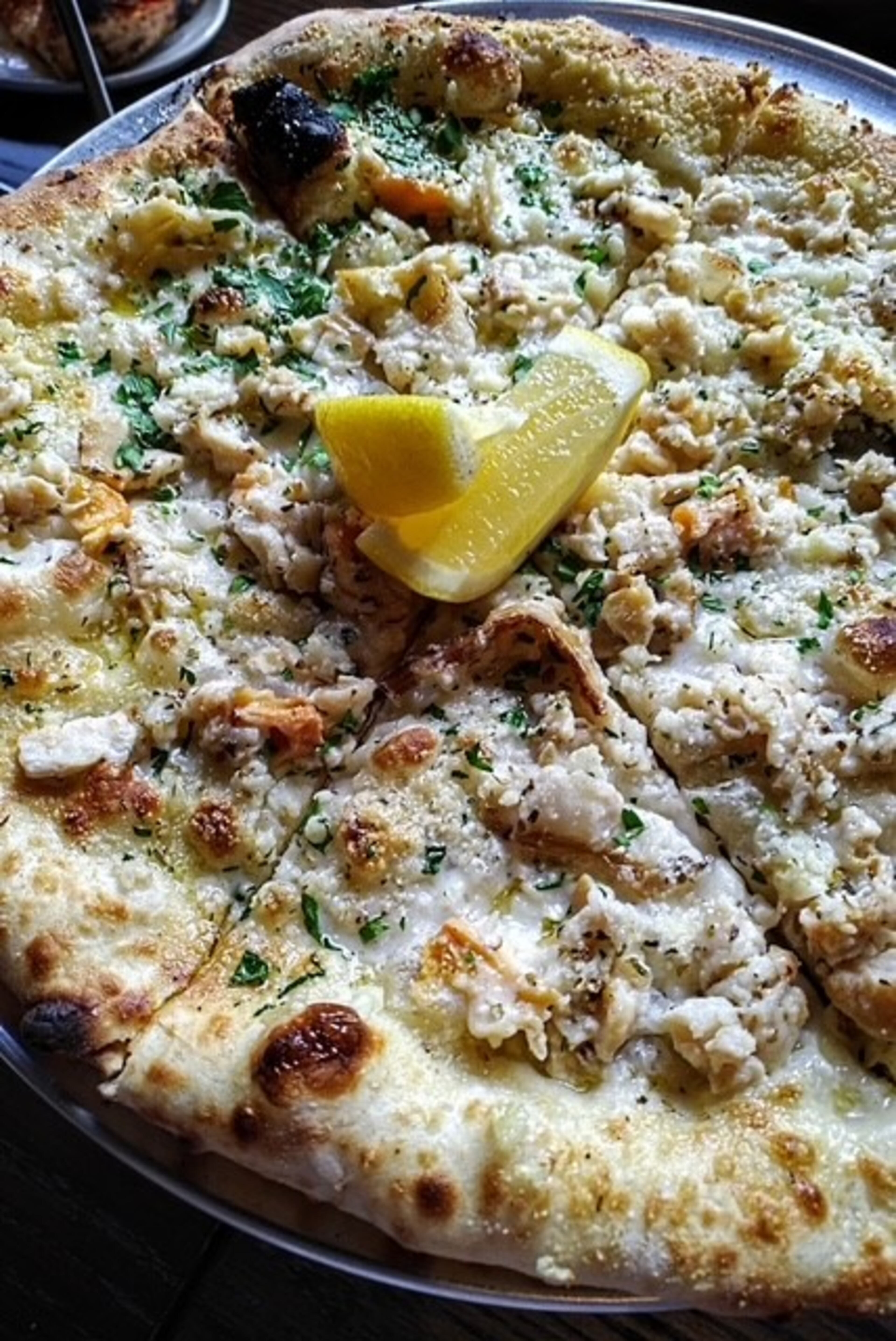 Krog Bar has opened in Peachtree Hills with coal-fired pizza like the surf clam. (Courtesy of Krog Bar)