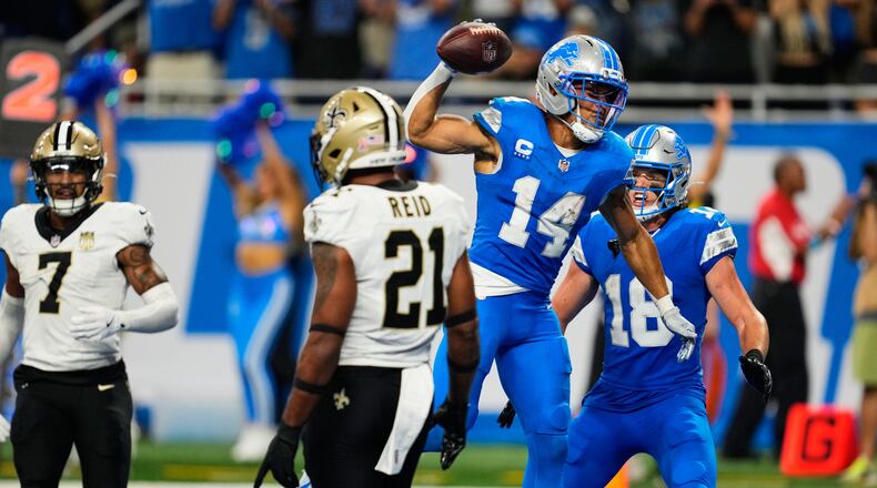 Detroit Lions wide receiver Amon-Ra St. Brown (14) celebrates his touchdown reception during overtime of an NFL football game against the New Orleans Saints, Sunday, Sept. 13, 2026, in Detroit. (AP Photo/Paul Sancya)